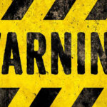 Warning sign with yellow and black stripes