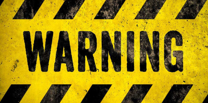 Warning sign with yellow and black stripes