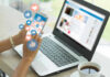 Person using smartphone and laptop with social media icons