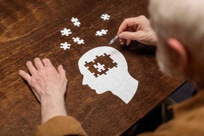 Elderly person completing head-shaped jigsaw puzzle