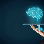 Digital brain above a hand holding a tablet