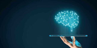 Digital brain above a hand holding a tablet