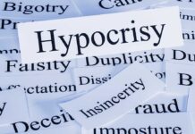A collection of paper cards with various negative term prominently featuring the word Hypocrisy