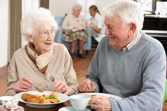 Elderly couple enjoying a meal together in a dining room