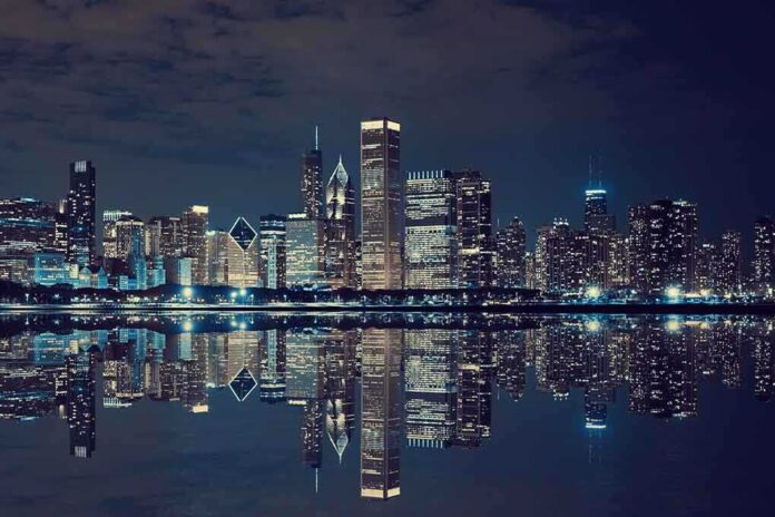 Nighttime view of a city skyline with reflections on water