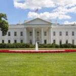 The White House with a fountain and flower beds in front