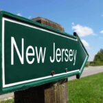 Directional road sign indicating New Jersey