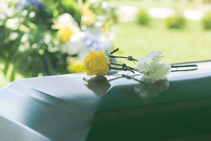 Flowers on a closed casket at a funeral
