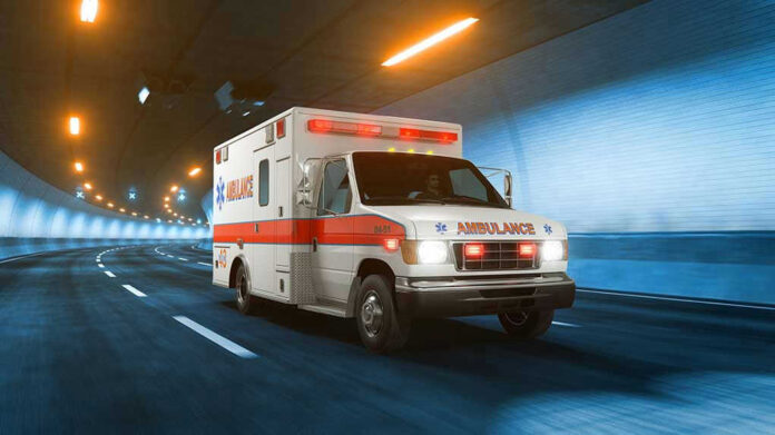 1159851319 Ambulance driving through a brightly lit tunnel.
