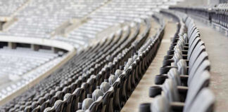 Empty rows of gray seats in a stadium