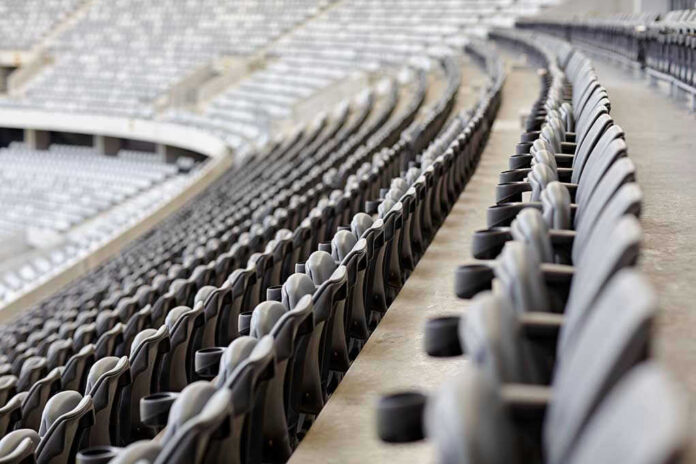 Empty rows of gray seats in a stadium