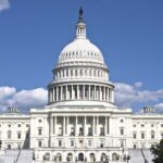 The US Capitol building under a clear blue sky
