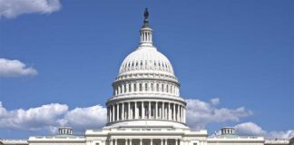 The US Capitol building under a clear blue sky