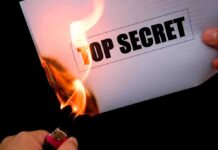 Why So SECRETIVE? — Navy Commandant’s ABRUPT Dismissal A hand holding a lighter igniting a paper labeled TOP SECRET as it catches fire