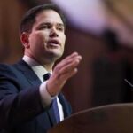Rubio Ignites Caribbean Firestorm — Congress Powerless A man in a suit delivering a speech at a podium