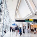 Knife-Wielding Intruder STOPS Airport Cold Interior of an airport terminal with travelers and signage
