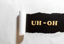 Jewel Thief Swallows Fortune – Now What? Torn paper revealing UH-OH text underneath.