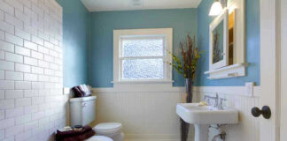 Modern bathroom with blue walls and white fixtures.