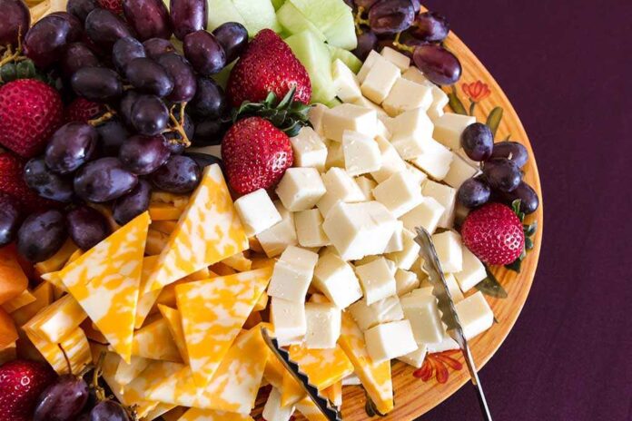shutterstock_154648751.jpg A colorful cheese and fruit platter featuring various cheeses and fresh fruits