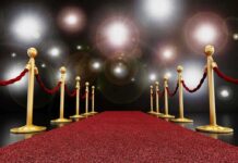 HOLLYWOOD Goes DARK–WHY IT’S LEAVING California A red carpet lined with gold stanchions and ropes under bright spotlights