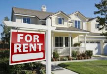 A house with a For Rent sign in the front yard
