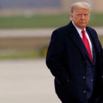 Donald Trump walking outdoors in formal attire