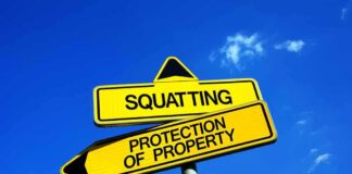 Two yellow signs indicating Squatting and Protection of Property against a blue sky