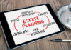 Tablet displaying estate planning related terms nearby coffee cup