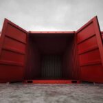 Open red shipping container with a view into the empty interior