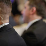 Bullet Survivor DEFENDS Secret Service — UNEXPECTED Security personnel with earpiece in a suit.