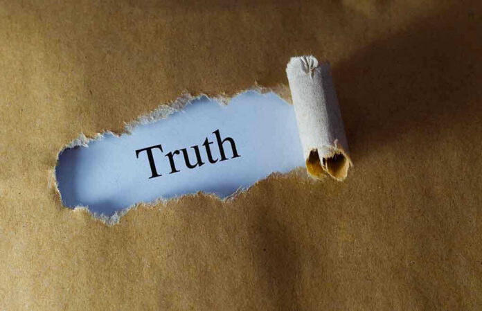 384729706 Ripped paper reveals word truth underneath brown surface