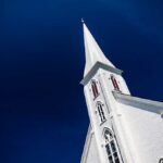 A tall church steeple against a clear blue sky