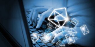Hands typing on a laptop keyboard with floating email icons