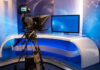 Megyn Kelly’s Iran CLAIM — Shocking BACKLASH TV studio with camera and empty anchor desk.