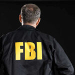 GOVERNOR Candidate Mocked Trump Assassination — FBI Arrives FBI agent with back facing the camera.
