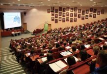 Grade Inflation CRISIS at Harvard – EXPOSED! Students seated in a lecture hall listening to a presentation