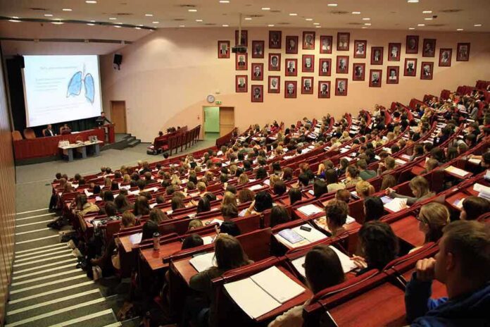 Students seated in a lecture hall listening to a presentation