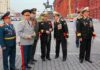 Group of military officers in uniforms holding flowers in Red Square