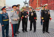 Group of military officers in uniforms holding flowers in Red Square