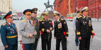 Group of military officers in uniforms holding flowers in Red Square