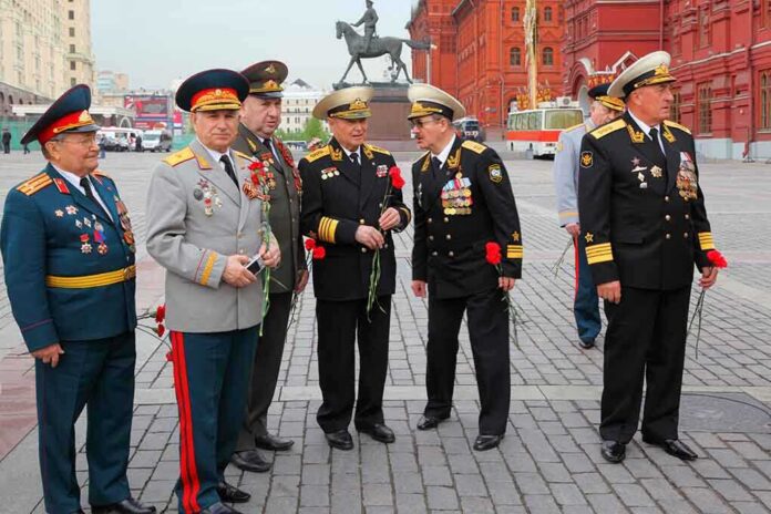 Group of military officers in uniforms holding flowers in Red Square