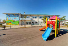 Daycare Horror Tied to Ex-Lawmaker Colorful playground slide in front of a building.