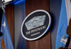 Pentagon Locks Out Press—Court Be Damned The Pentagon emblem between two flags.