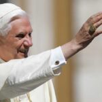 Pope Benedict XVI smiling and waving during a public appearance
