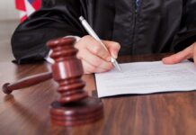 Full NDA Disclosure: Congress Turns Up Heat in Epstein Probe A judge signing a legal document with a gavel in the foreground