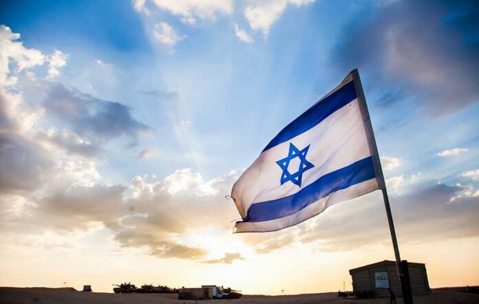 Israel Israeli flag waving against a sunset backdrop with clouds