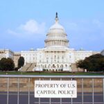 View of the U.S. Capitol building with a security barrier in front