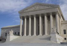Appeals Showdown: Leader’s Name Comes Down The Supreme Court building featuring large columns and statues