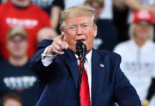 Supreme Court Smacks Trump — Chaos Ensues Man in suit pointing, speaking at a rally.