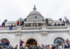 Court Clears Four Proud Boys of Conspiracy Convictions Crowd gathered on steps of Capitol building.